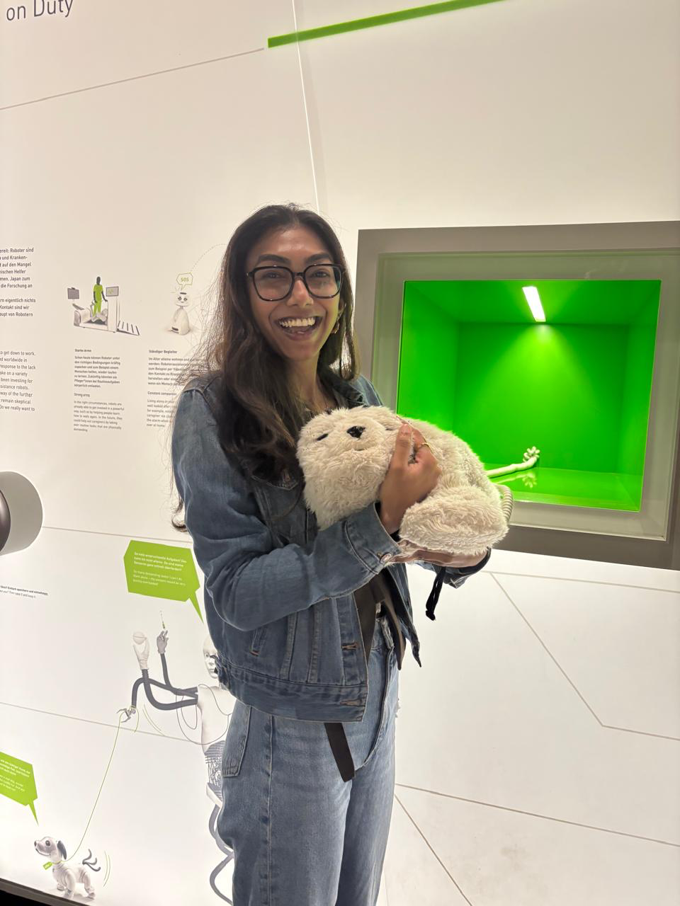 Sushmita holding a robot seal at a museum