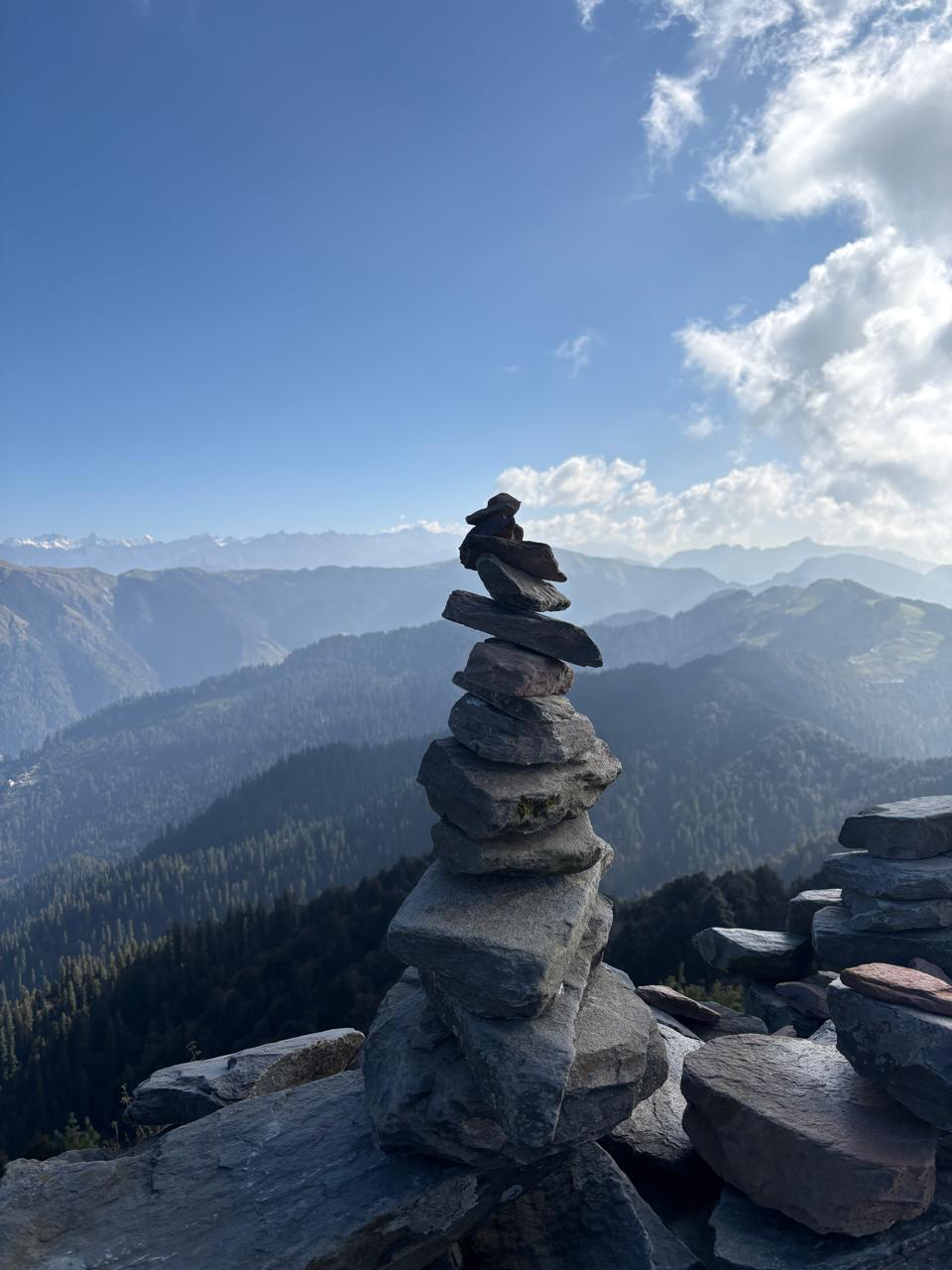 A stacked-stone cairn in the mountains