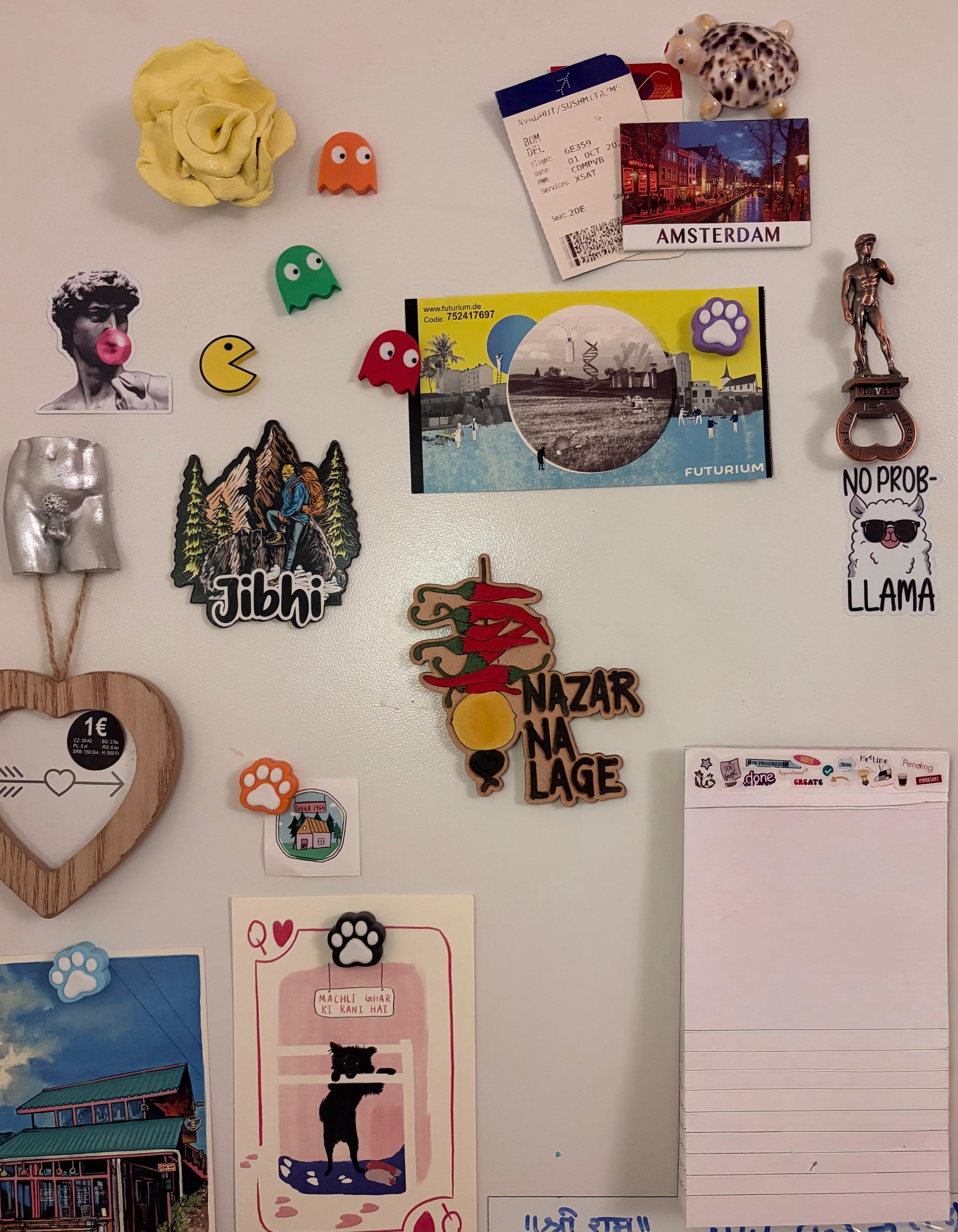 Fridge covered in travel magnets, stickers, and postcards